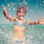 Happy child playing in the sea